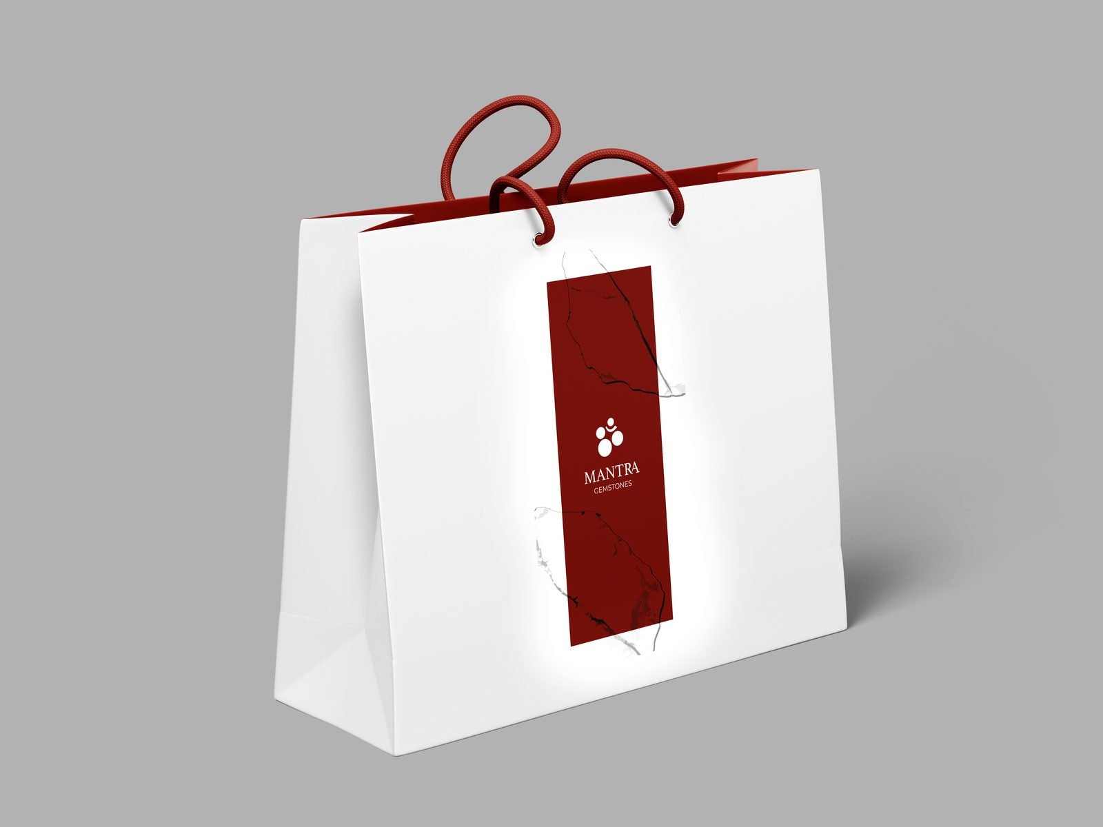 Mantra Gemstones: White shopping bag with the red Mantra band